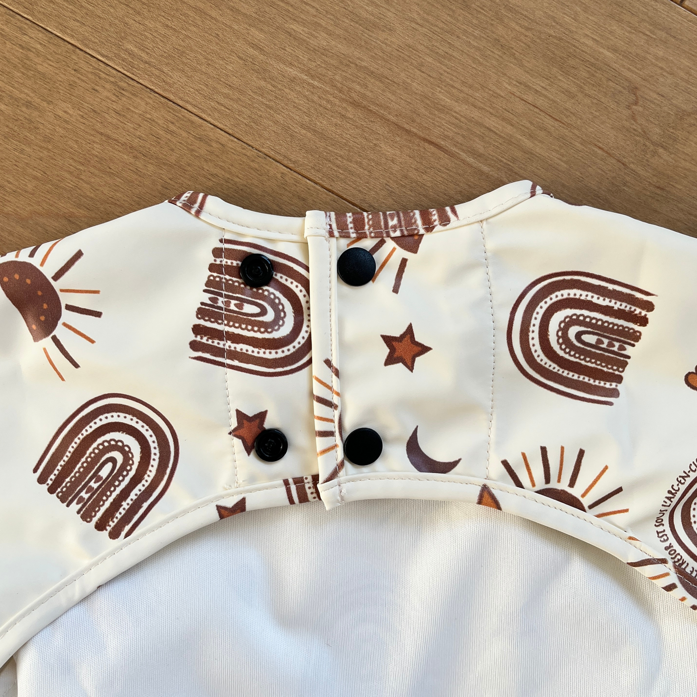 Long-sleeved waterproof bib with pocket: Radiant Sun BOHO (cream background)